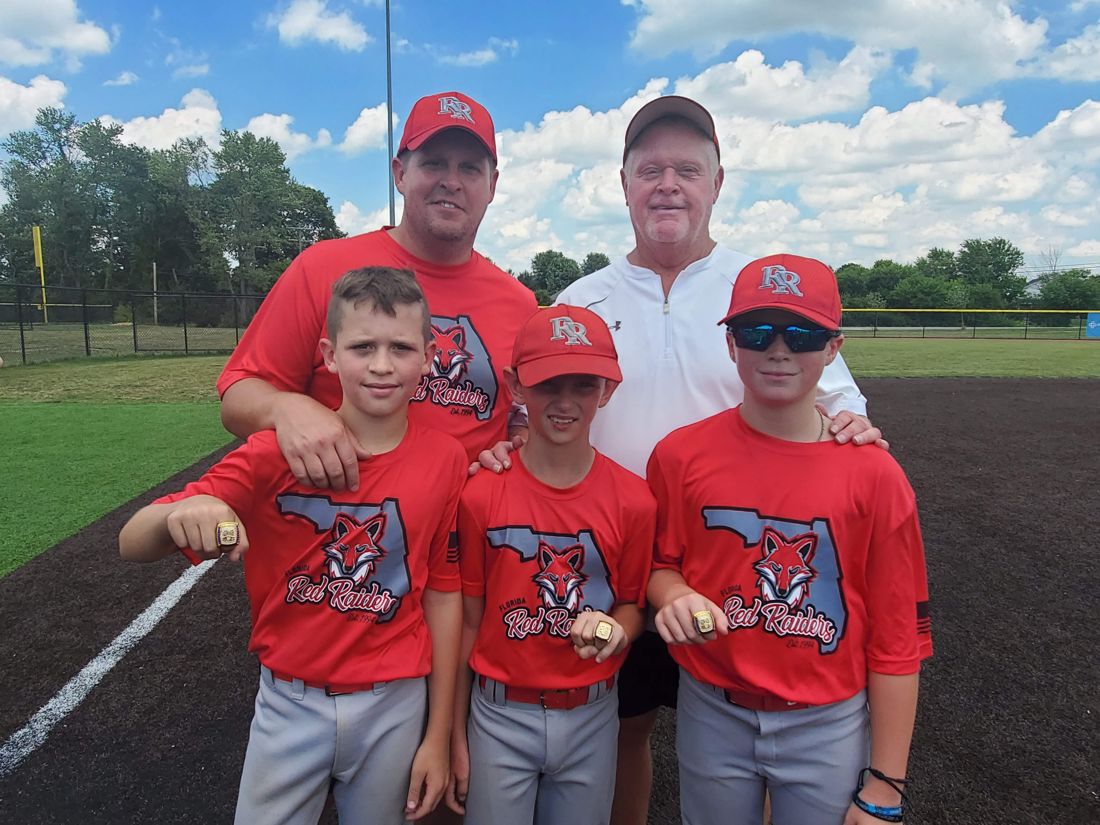 Coach Rick with his son Ricky and three grandsons showing off their championship rings