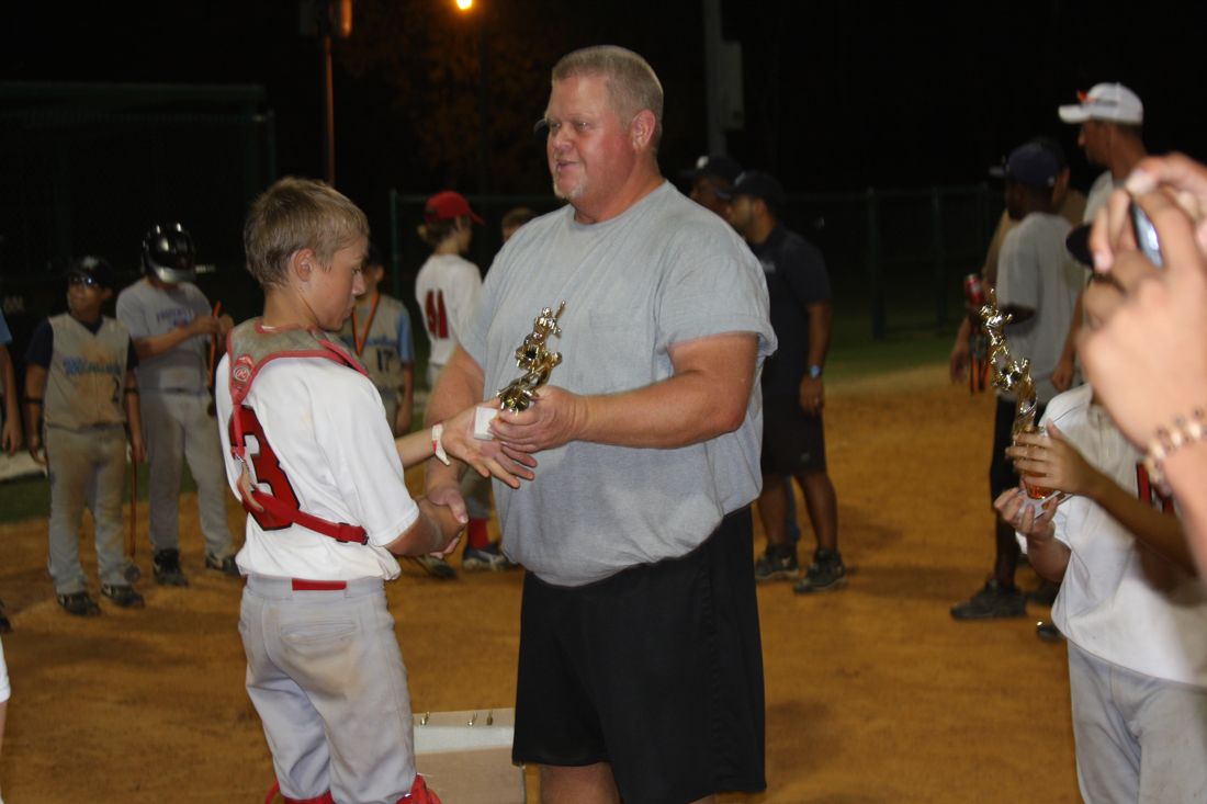 Coach Rick handing out trophies after a night game
